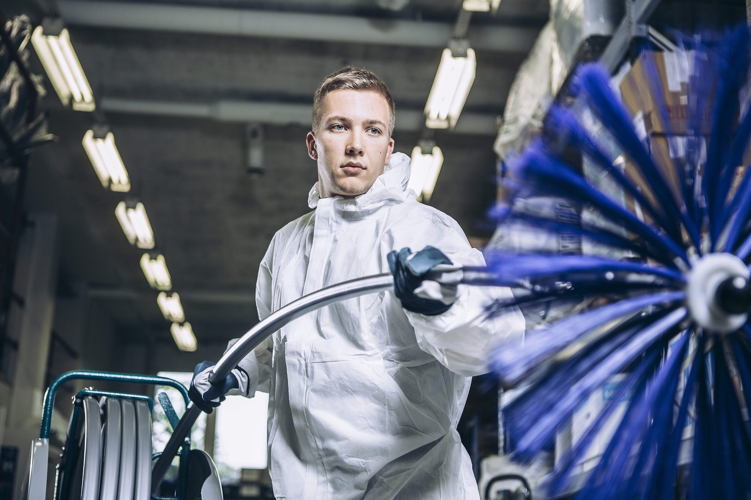 Industrial kitchen cleaning worker holds a ventilation element